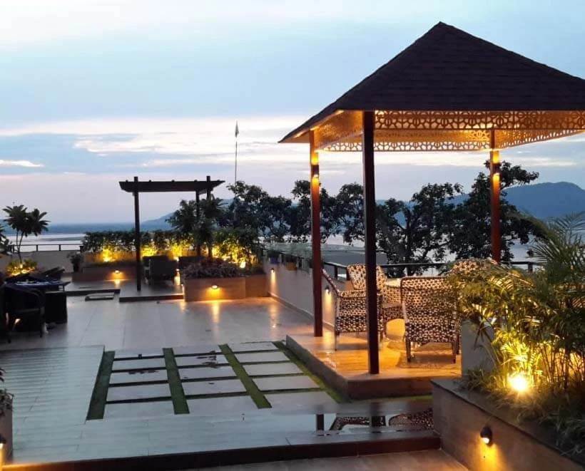 Terra Mansion rooftop landscape with a gazebo and warm lighting at dusk